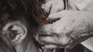 Photo of Keely Nilan's mother braiding her sister's hair with embroiders for color and texture