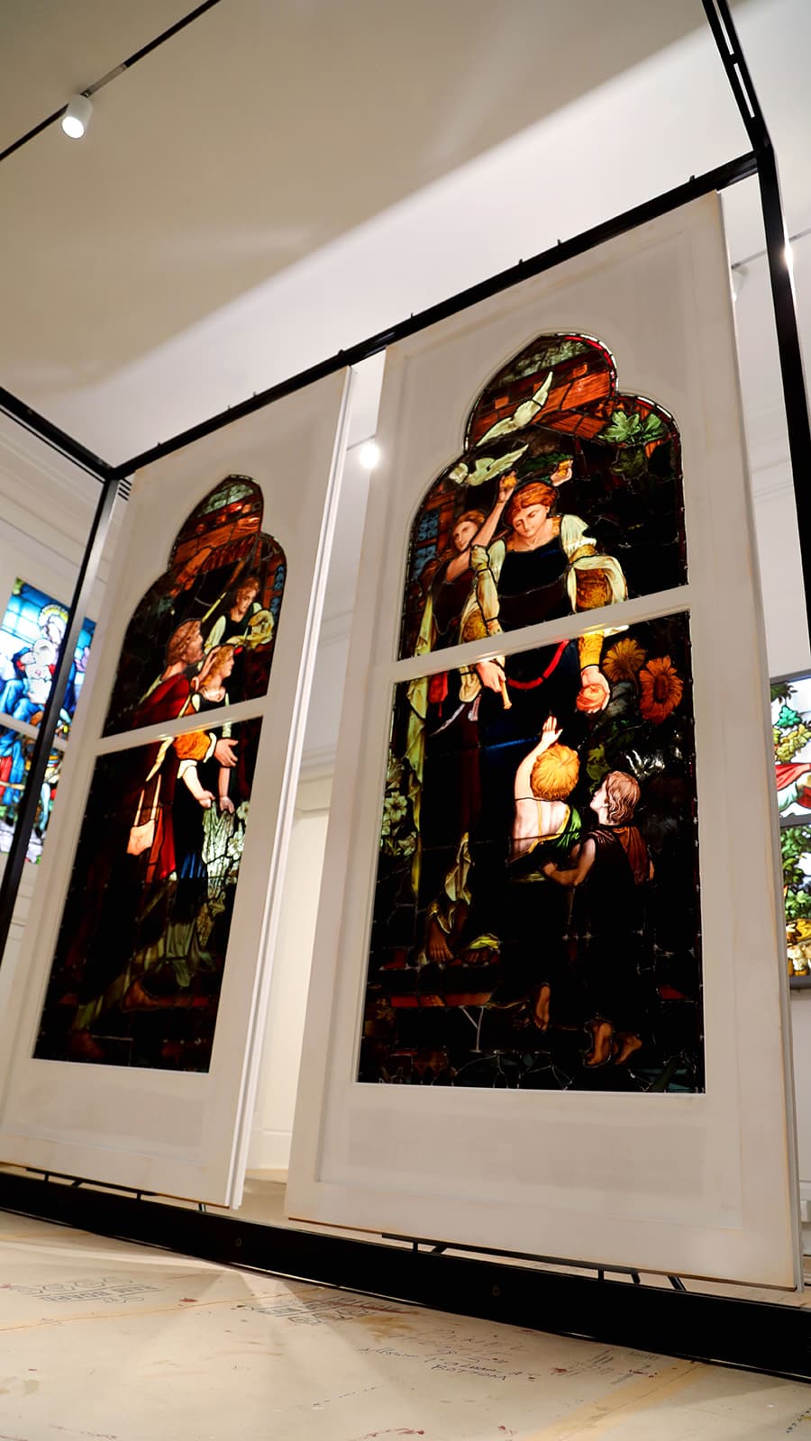 Two door-like panels featuring stained glass art in Maguire Museum at Saint Joseph's