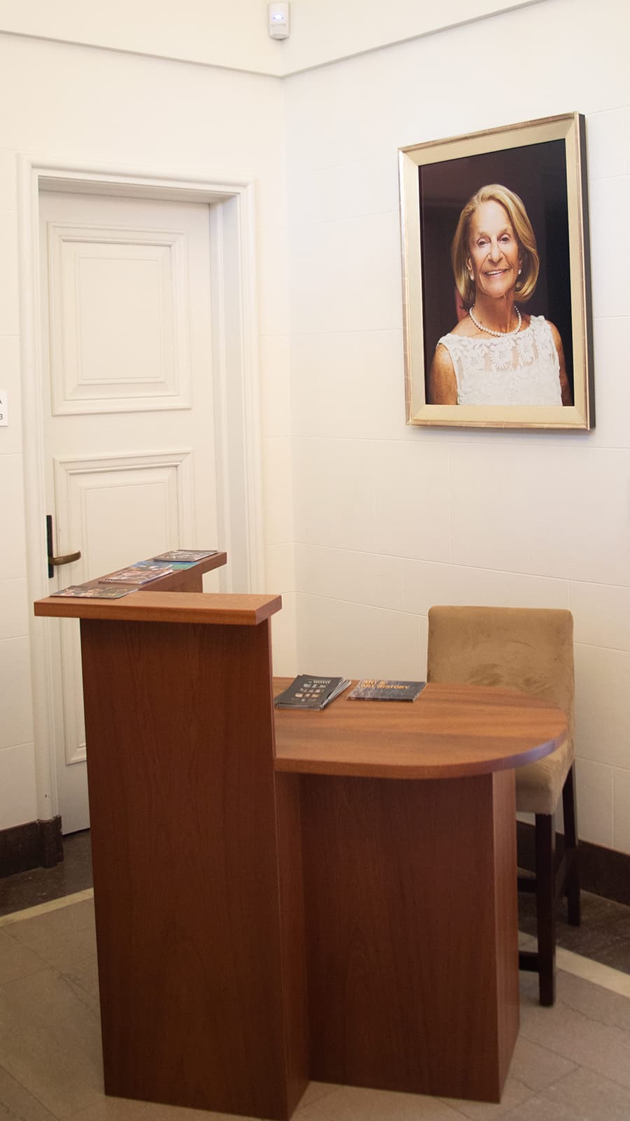 Wooden office desk with photo of Frannie on the wall behind the desk